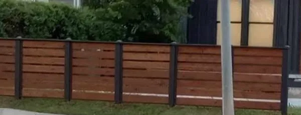 Horizontal cedar privacy fence with black steel-look posts