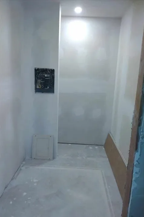 Freshly finished drywall in a utility room ready for texture and paint